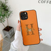 Orange iPhone case with a brown H and horse design.