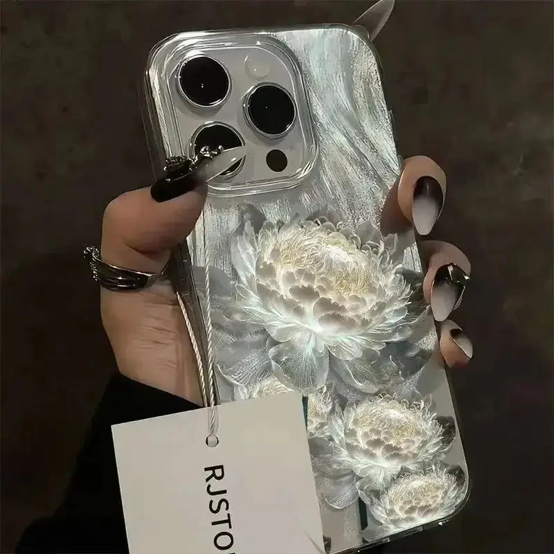A hand holds a transparent phone case with a raised white lotus pattern and a feather texture.