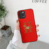 Red leather iPhone case with a brown horse and "H" logo.