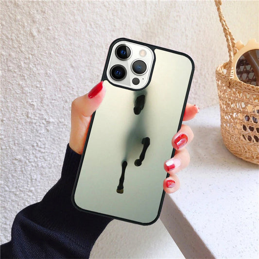 A hand holds an iPhone with a reflective case featuring a running horse design.