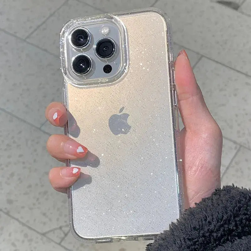 A hand holds a clear glitter phone case on a light-colored iPhone.