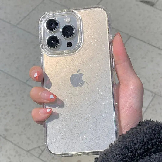 A hand holds a clear glitter phone case on a light-colored iPhone.