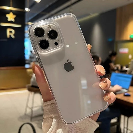 A hand holds a transparent phone case on a white iPhone with a triple camera.